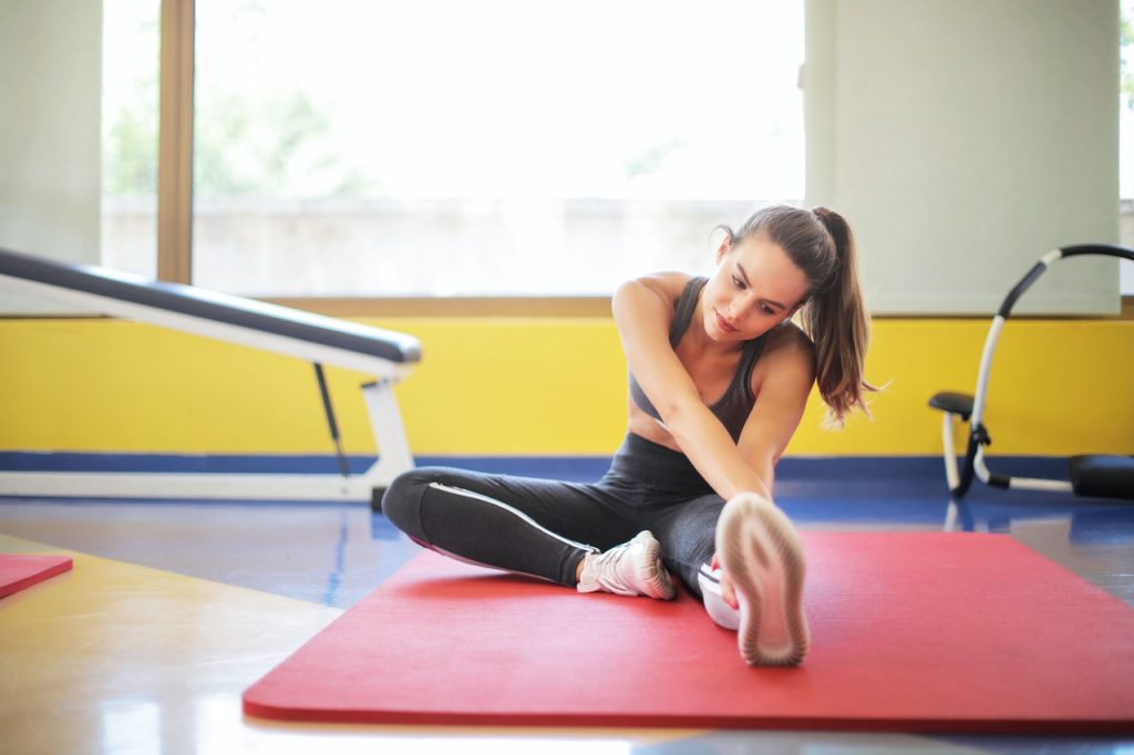 Woman At Gym Stretching