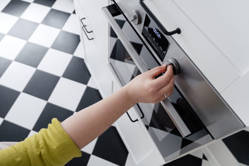 Hand Turning on Oven